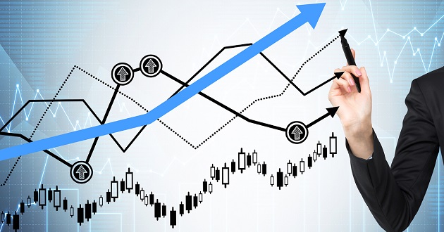 Woman's hand is drawing a growing graphs. Forex chart on the background.